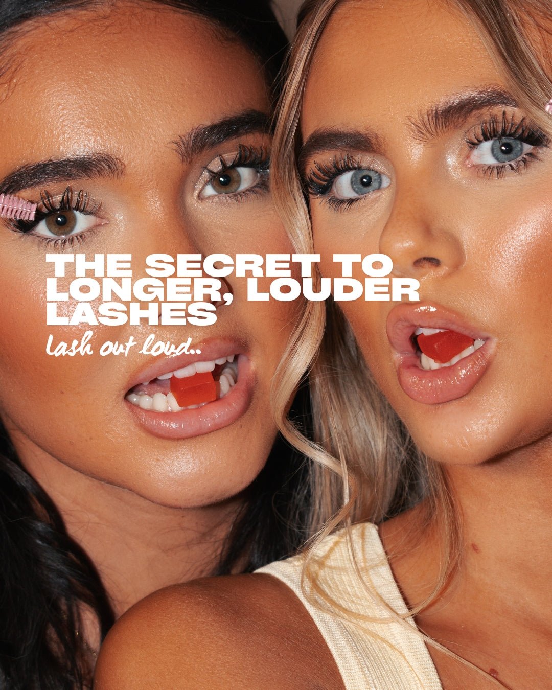 Two females with red gummies in their mouths holding an eyelash spoolie
