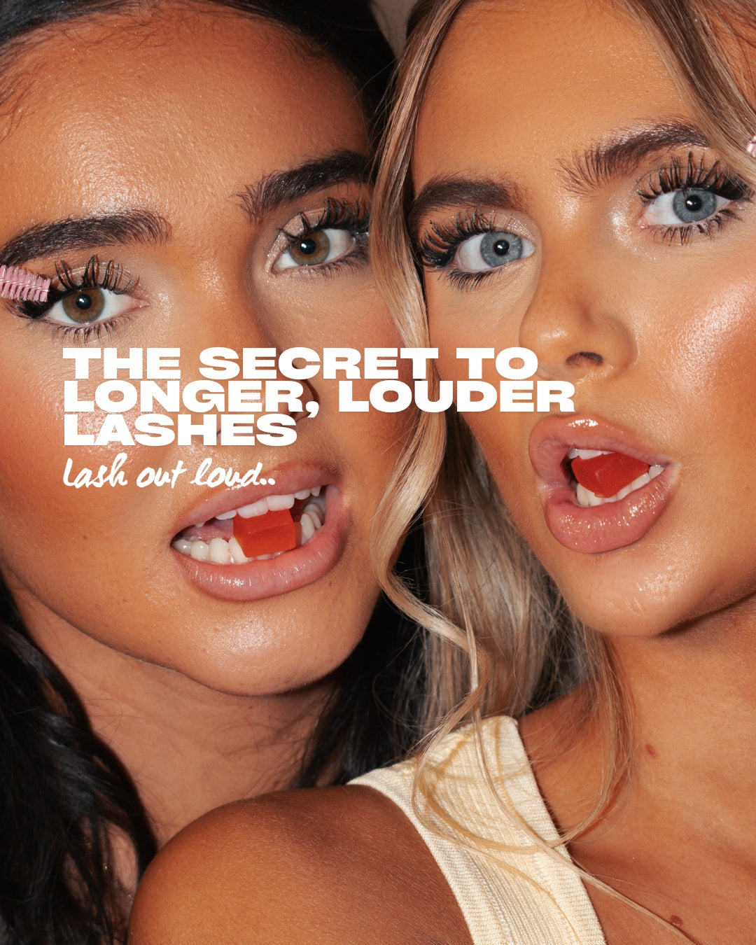 Two females with red gummies in their mouths holding an eyelash spoolie