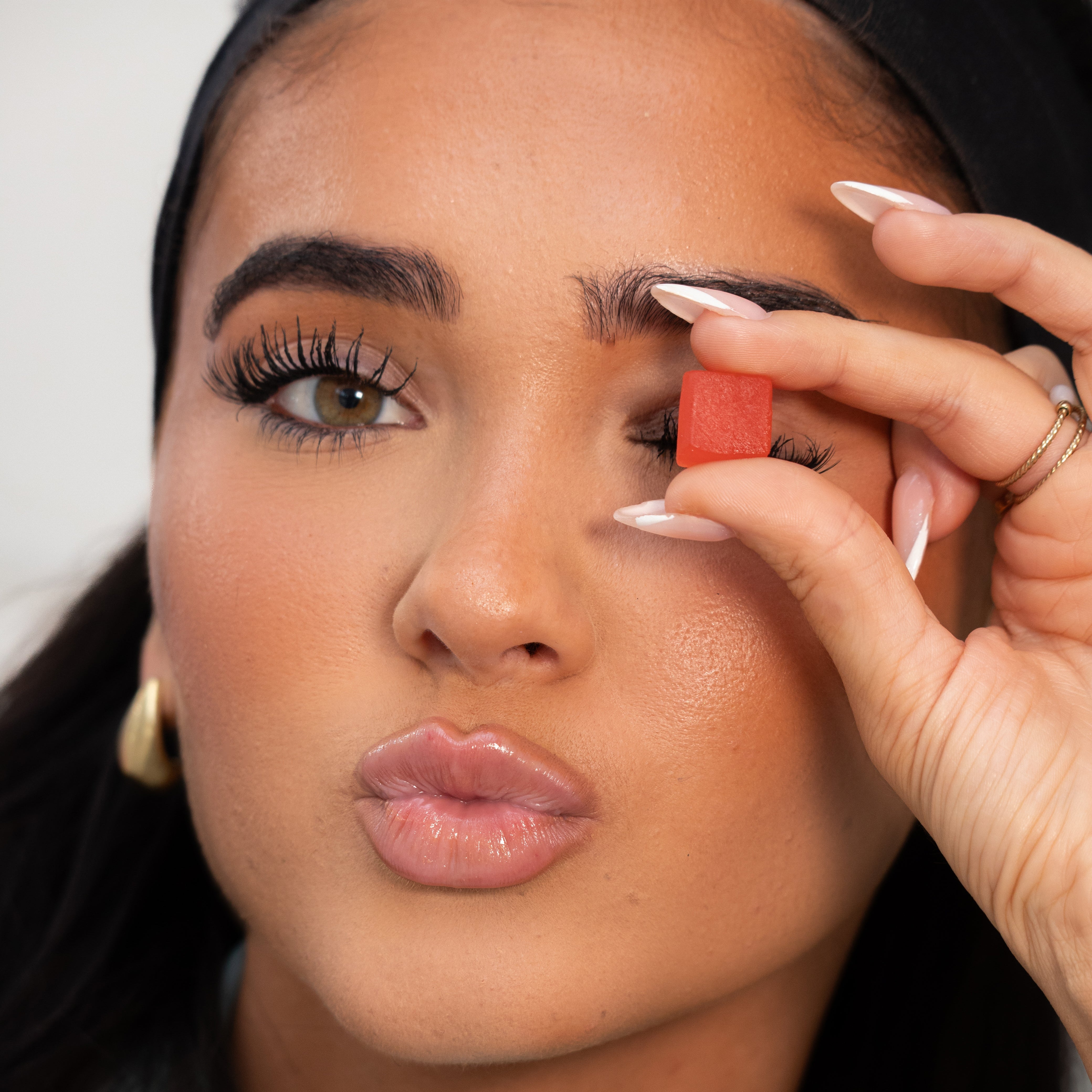 Woman applying makeup with a small mirror